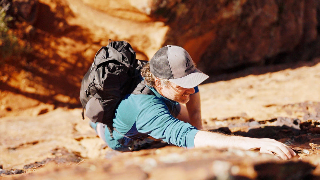 A rock climber wearing the Pingora Focus 25L climbing and hiking backpack