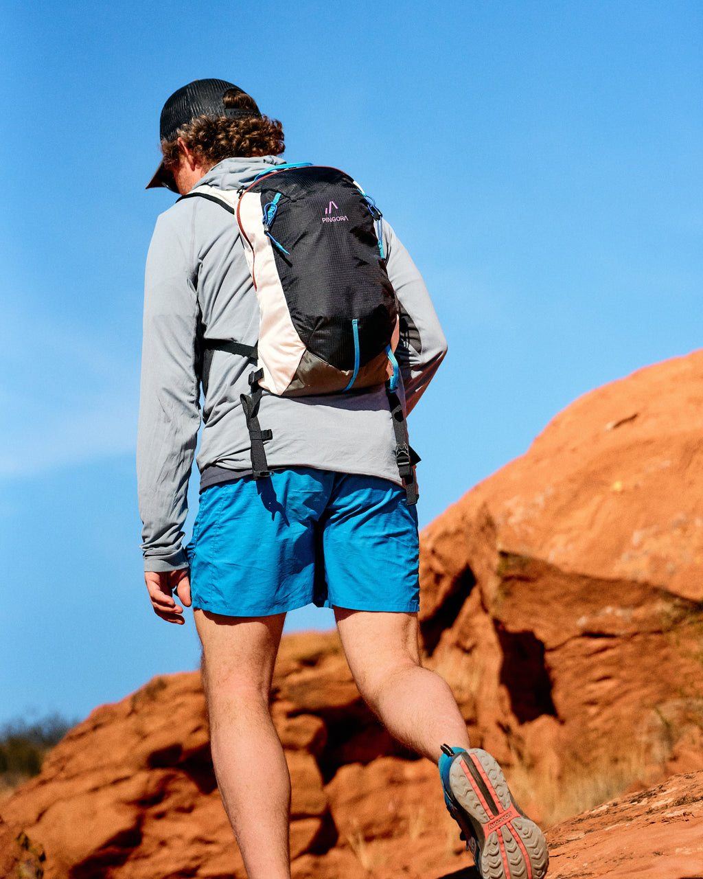 Pingora Lucid 13L Hiking Backpack harness view showing the pack being worn on a hike.
