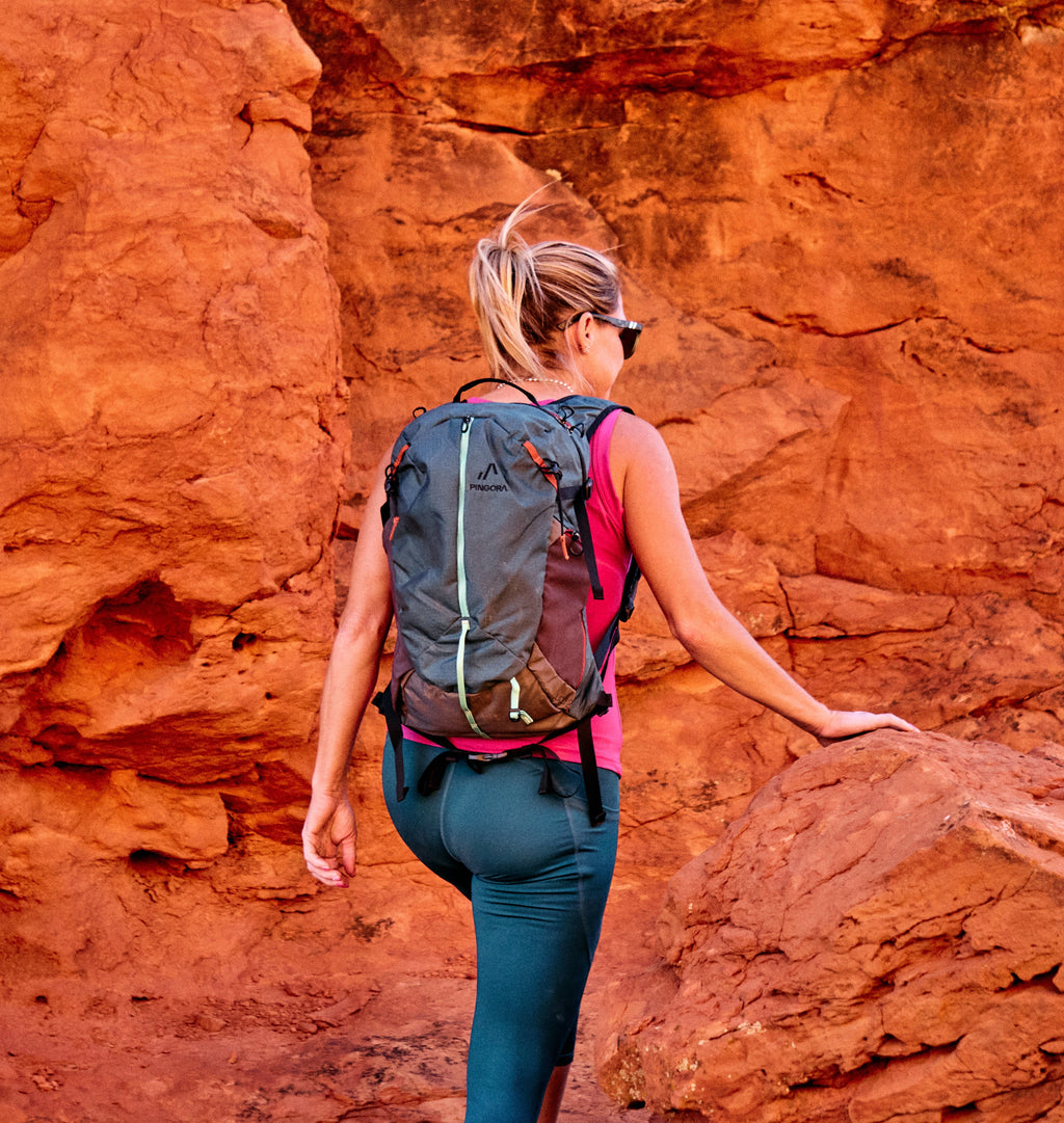 Pingora Lucid Hiking 20L backpack showing front zipper and side pocket in ocean blue color shown on live model.