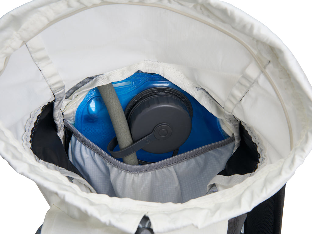 Pingora Focus 15 liter climbing and hiking backpack in white and black showing how a hydration system fits inside the pack