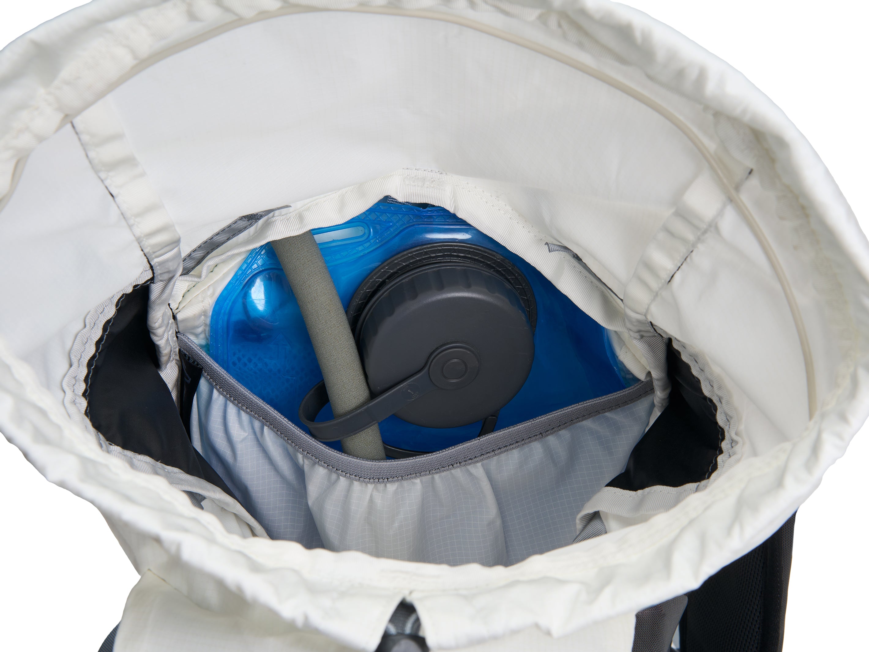 Pingora Focus 15 liter climbing and hiking backpack in white and black showing how a hydration system fits inside the pack