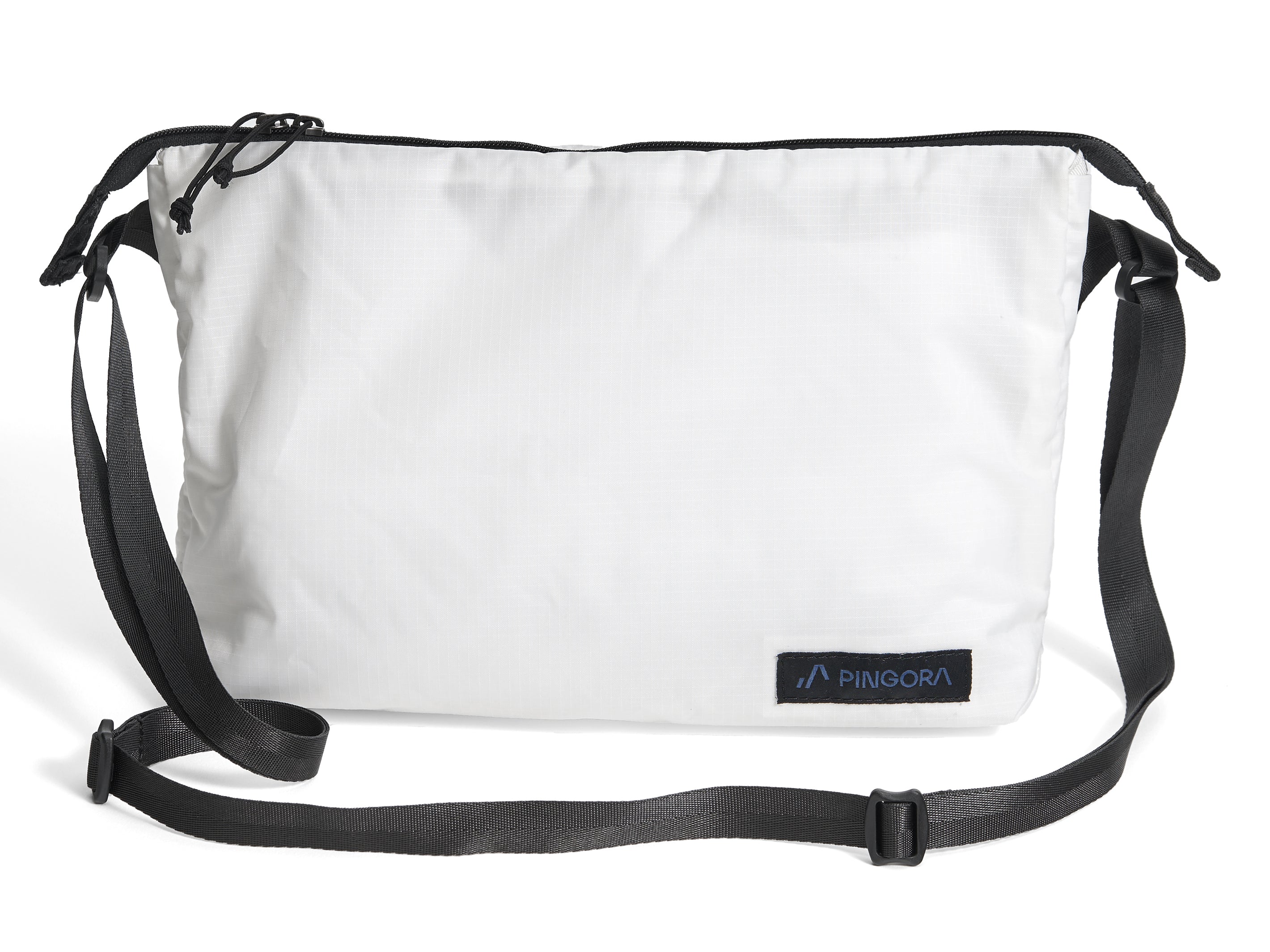 Pingora Satchel in white with black straps and a small blue logo on the front, designed for carrying items while backpacking or traveling.