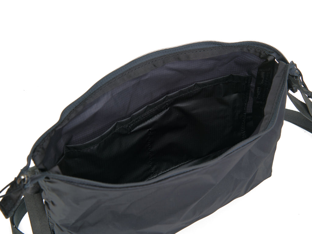 Pingora Satchel in black with black straps showing inside of bag