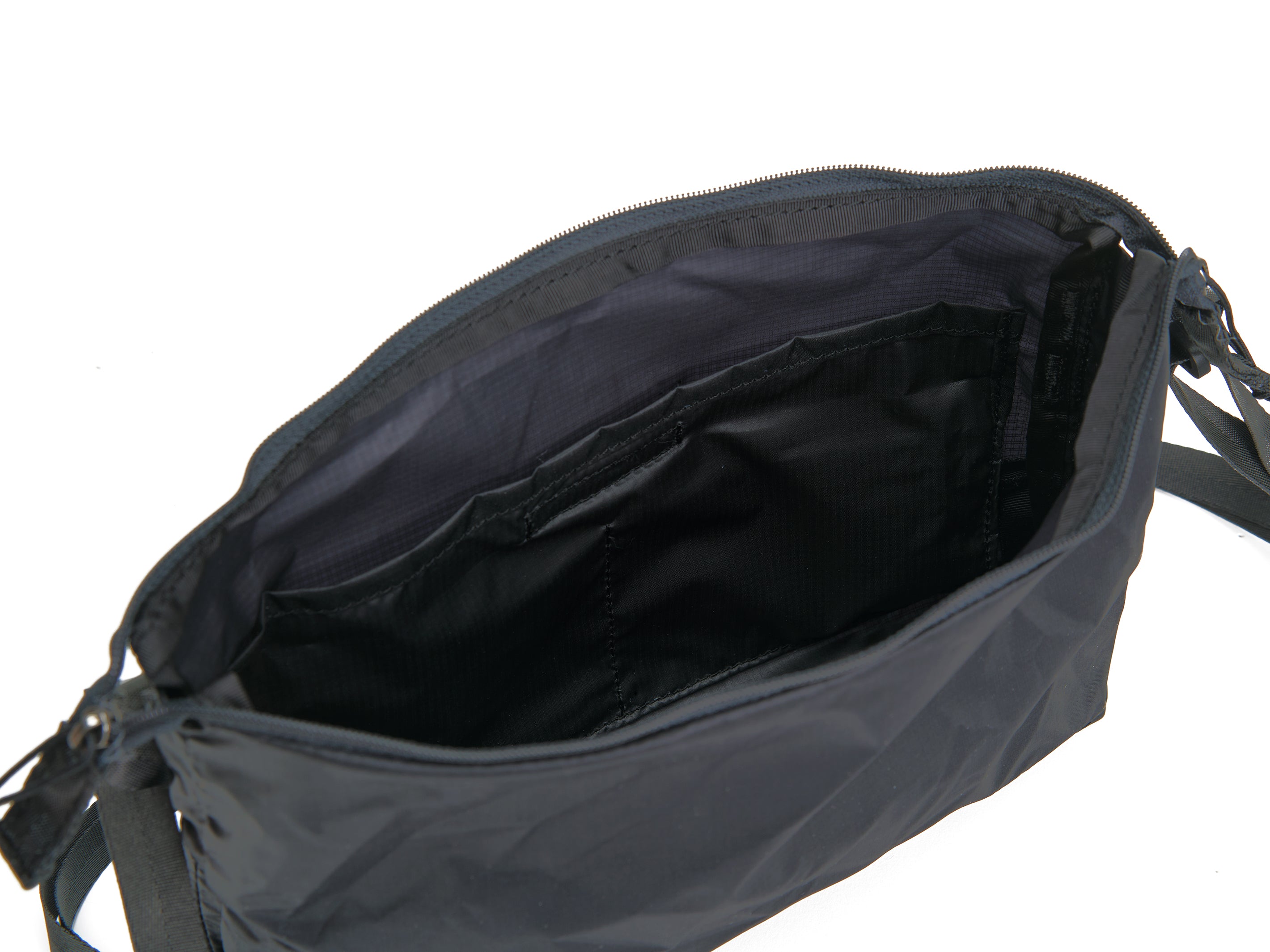 Pingora Satchel in black with black straps showing inside of bag