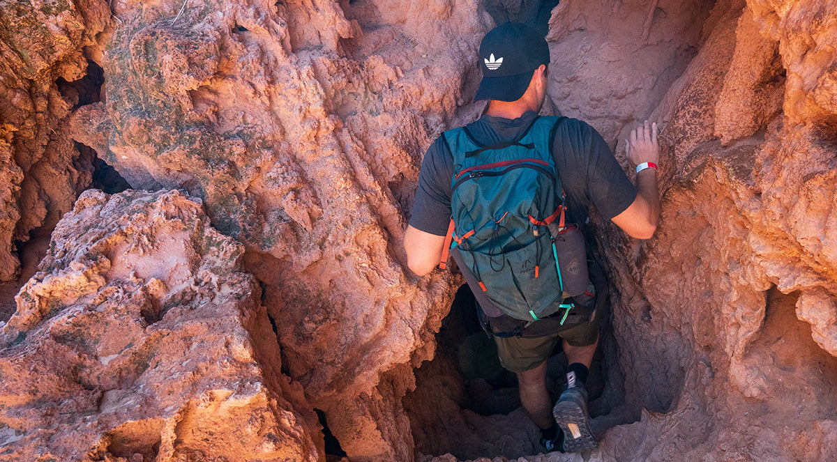 Pingora Lucid 25 litre hiking backpack shown on model hiking red rock country