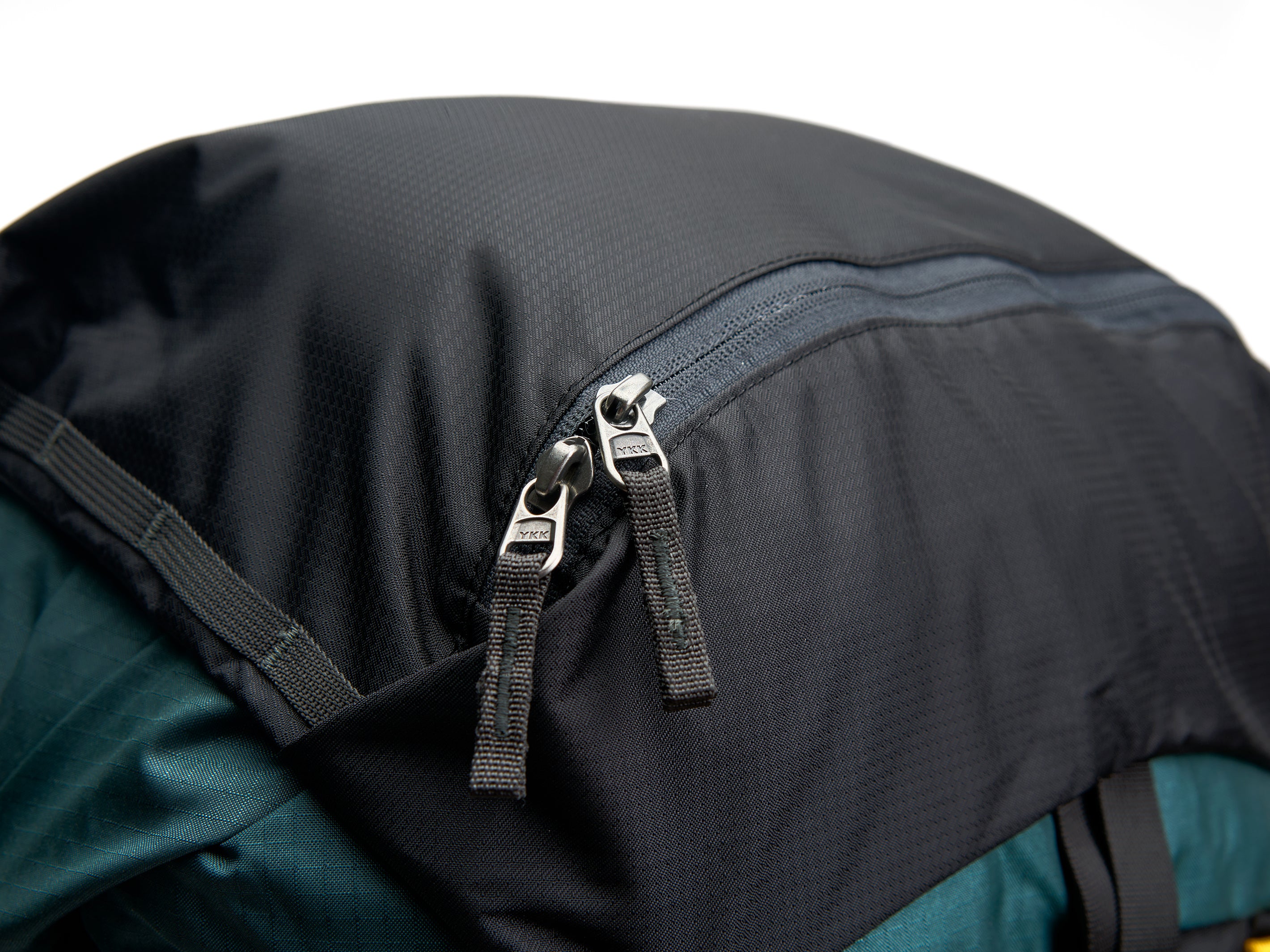 The Pingora Top Pocket for additional backpack storage, branded Pingora, with a zipper closure and a clip attachment. Showing the top pocket attached to an Outro backpack